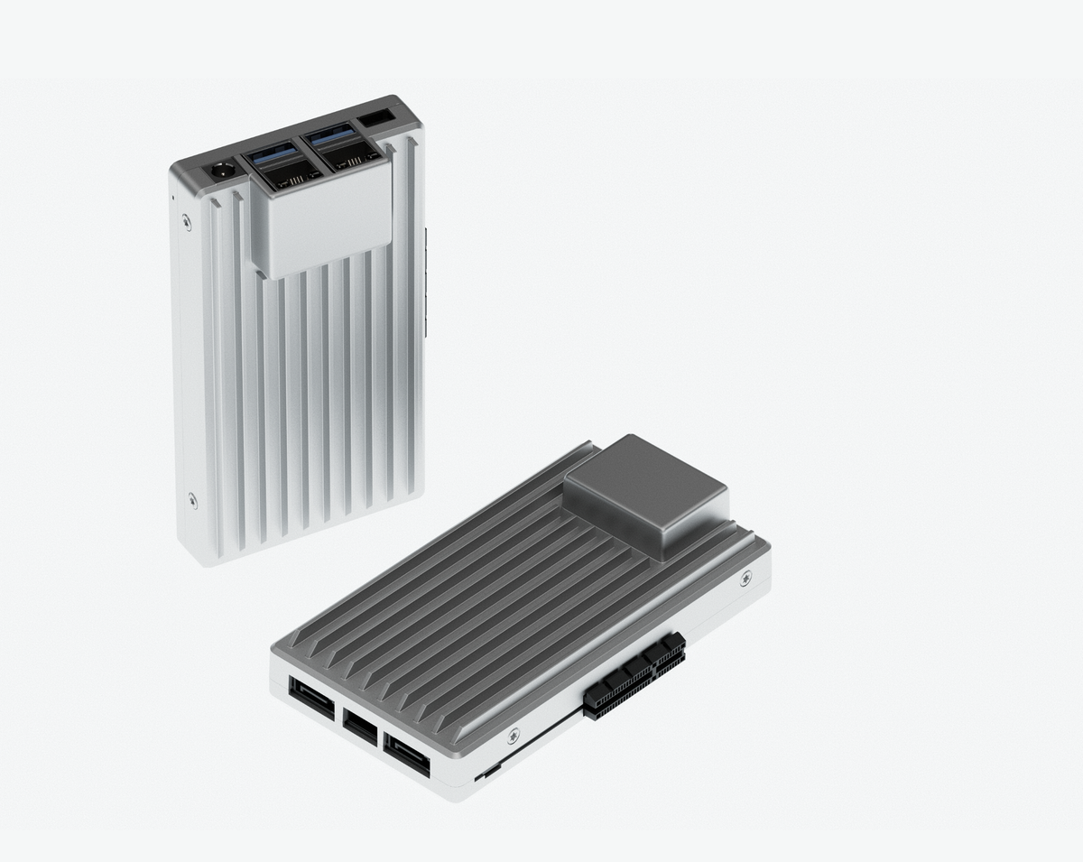 Two Zimaboard 2's one standing vertically the other laying horizontally against a white background. They are single board computers in a gray gray aluminum case.