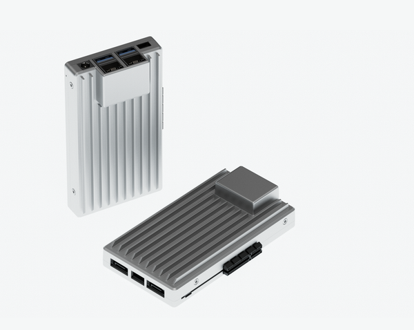 Two Zimaboard 2's one standing vertically the other laying horizontally against a white background. They are single board computers in a gray gray aluminum case.